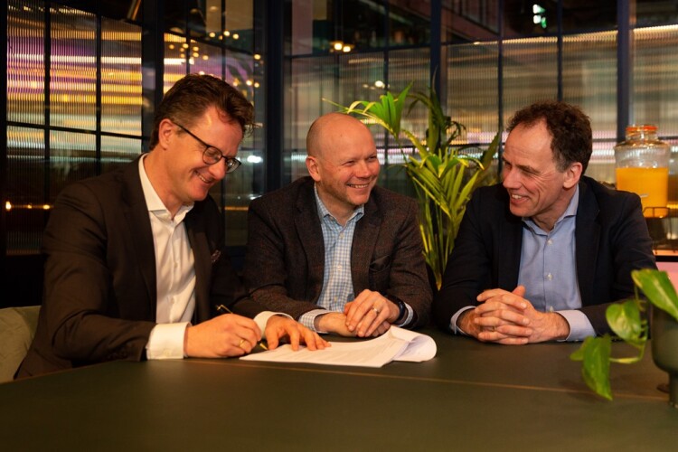 AA Projects managing director Ken Wood (centre) with Drees & Sommer partners Sascha Hempel (left) and Michel da Hann (right) signing the original takeover deal in March 2022