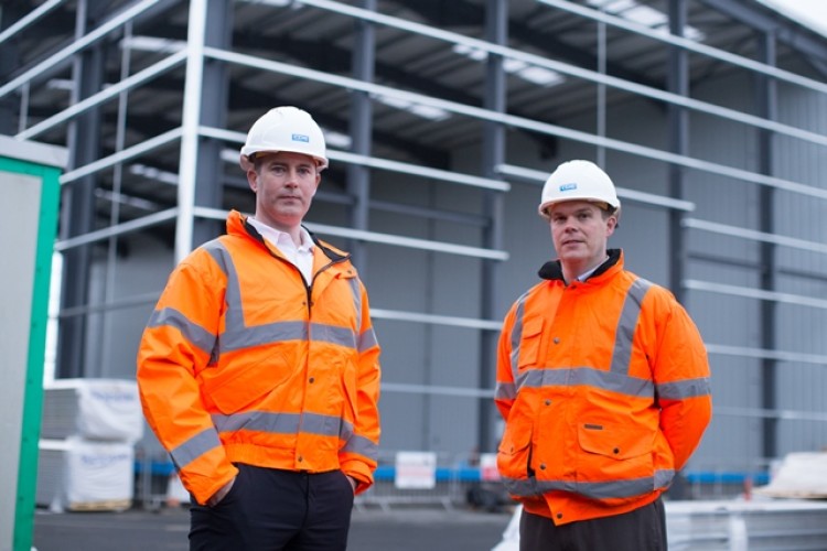 CDE operations director Raymond Cooke and finance director Colin Trainor outside the new factory hall