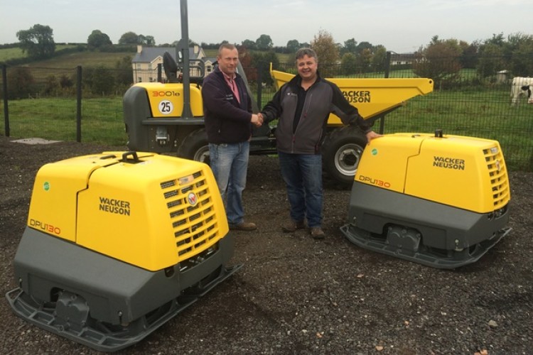 CP Dynes contracts manager Andrew Cochrane (left) takes delivery of the Wacker plates from Glendun Plant director Derek Weir
