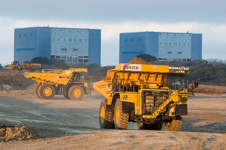 100-tonne dumpers working on the Hinkley Point C site in 2014, in front of Hinkley Point B 