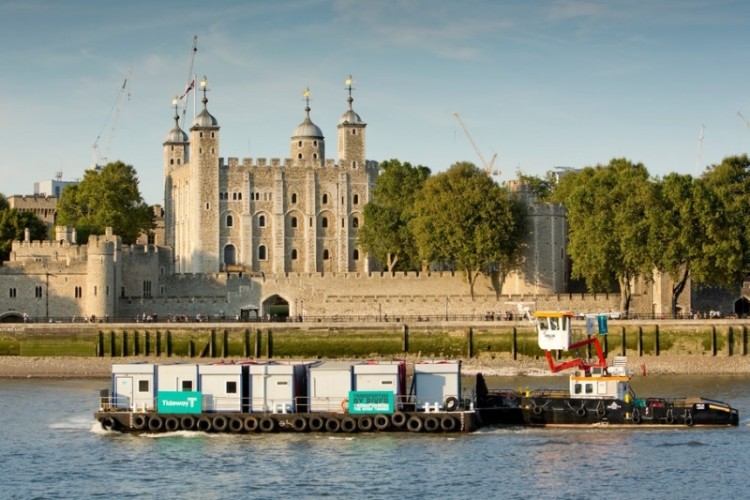 The tug boats carrying site huts through central London