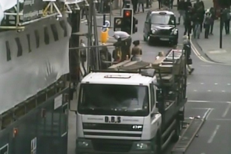 An extract from the CCTV footage showing the unsafe scaffolding work, with poles passed over the heads of shoppers