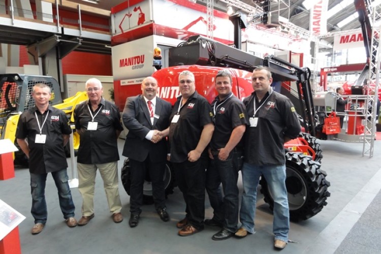 Tony Hobbs of Manitou UK (third from left) seals the deal with GT Access managing director Jonathan Till (fourth left) at a recent trade fair.