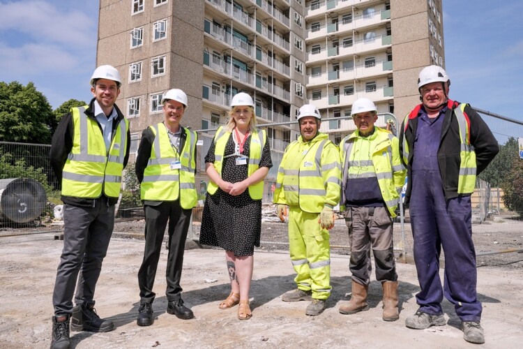 Connell Bros manager Gerard Kelly, left, with the council&rsquo;s chief housing officer Gerrard Tinsdale and Councillor Jessica Lennox, executive member for housing. The names of the three site operatives on the right were not supplied