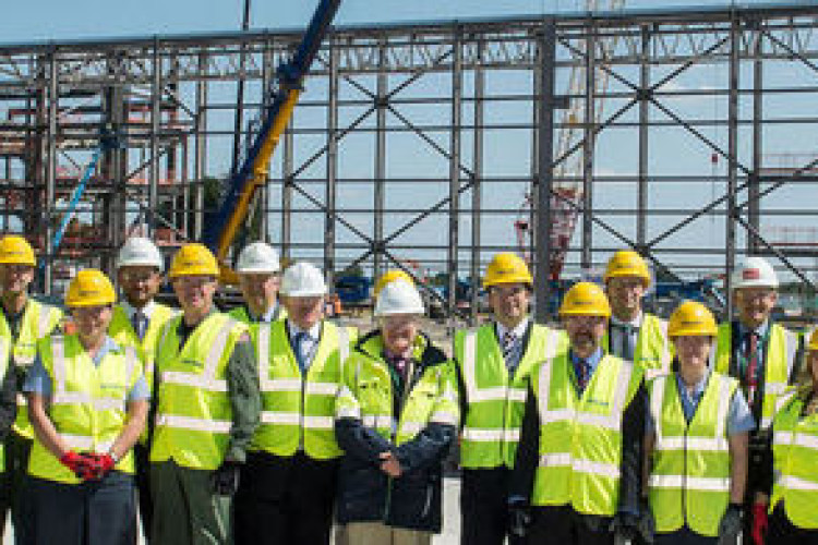DIO project manager Denis Williams (front centre) with partners celebrating the first stage of the hangar&rsquo;s steelwork. (MOD Crown Copyright)