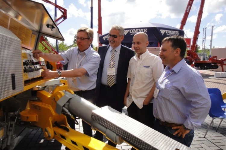 Omme Lift's Carsten Poulsen demonstrates the new machine to Jim Daintith of IAPS Group and Lee Kerr and Scott Bone from Paramount Platforms 