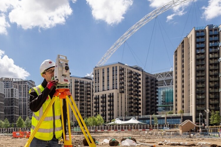 The arch of the new Wembley Stadium looms over the development site