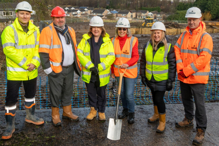 Jon Liggett (Housing 21), Cllr Graham Turner (Kirklees Council), Clare Hemming (Housing 21),  Cllr Jackie Ramsay (Kirklees Council), Lisa Jones (Homes England) and Jonathan Sizer (Robertson Construction) take turns with a spade