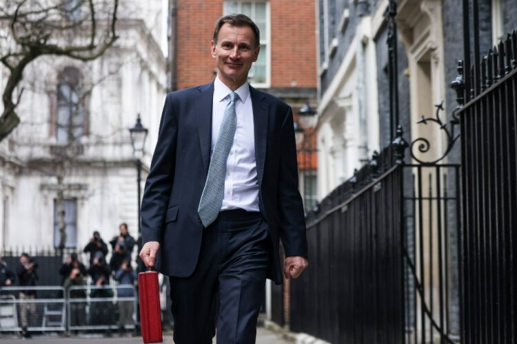 Jeremy Hunt leaves Dowing Street to deliver his budget to to parliament