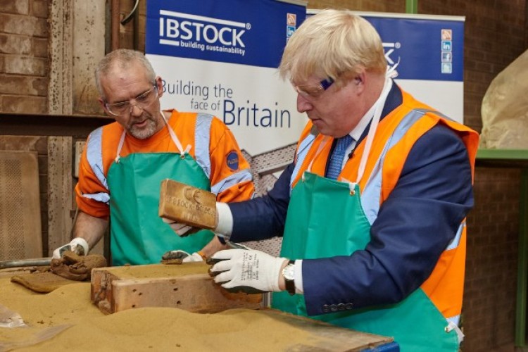 Boris makes a brick and, below, signs it
