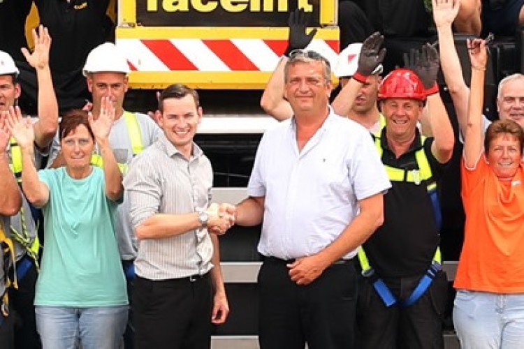 Paul Standing, left, and Gordon Leicester shake hands as (below) the whole team looks on