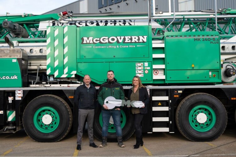 Liebherr GB general manager Simon Cook (left|) and sales manager Shola Russell hand over the new crane to Kieran McGovern (centre)