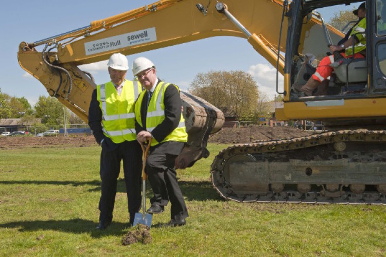 Sewell MD Paul Sewell helps vice-chancellor Calie Pistorius break ground