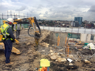 A remote-controlled Brokk robot was used to demolish the rooftop structures prior to construction of the extension