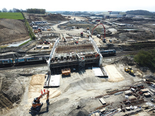 The bridge itself is a reinforced concrete structure with a single 28m clear span over the railway tracks