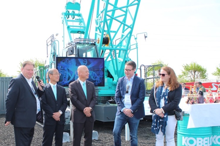 From left, Kobelco&rsquo;s Mark Evans Tasuku Aoyama and Kazuhide Naraki hand over the first crane to Anthony and Rosie Quinn at Intermat, Paris