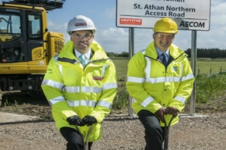 Transport secretary Ken Skates (left) cuts the turf