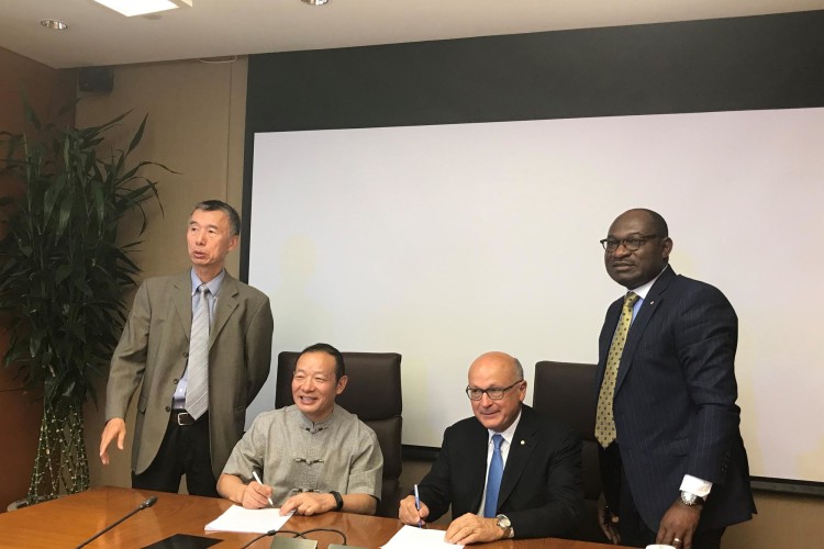 Nelson Ogunshakin (right) pictured alongside Alain Bent&eacute;jac and CECA chairman She Shi at the signing of the MoU in Beijing.