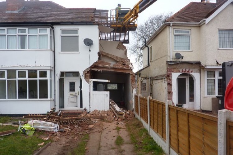 The partially collapsed house after the incident