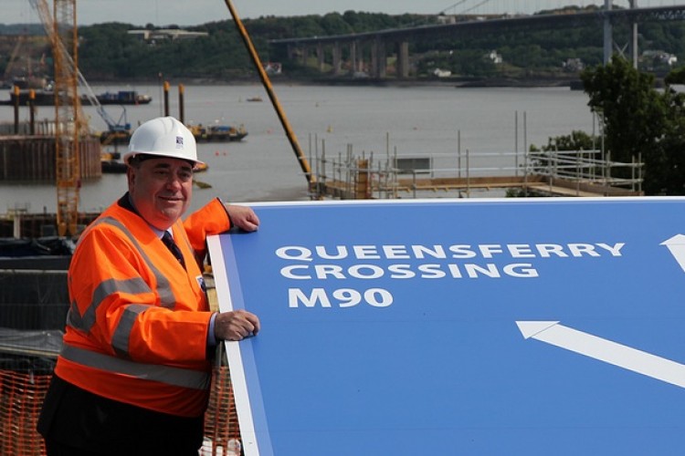 Alex Salmond helps put up the sign