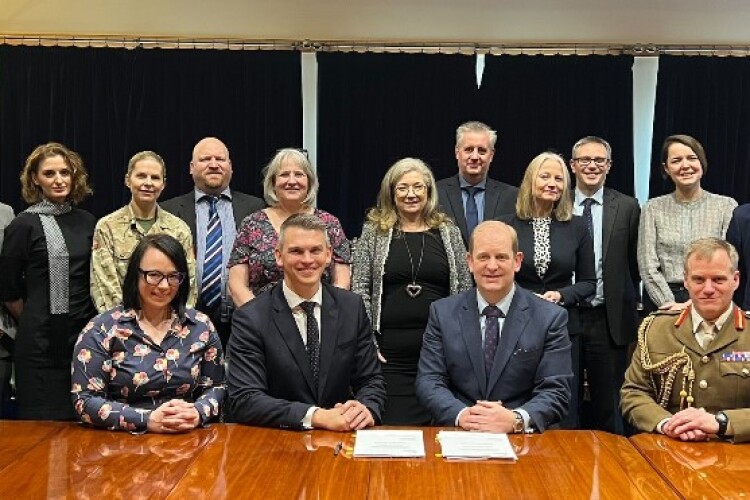 Ministry of Defence civil servants line up behind (l-r) Laing O&rsquo;Rourke preconstruction lead Rachael Cunningham, director Martin Staehr, DIO deputy director Jeremy Hollard and Major General Richard Clements, director B&I, Army