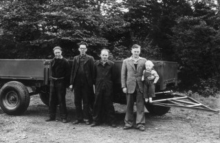 Pictured in 1947 are (left to right) Bill Hirst with employee number one Arthur Harrison, employee number two Bert Holmes and company founder Joe Bamford (holding current chairman Anthony)
