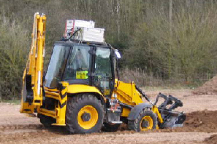 Portable emissions measuring systems are difficult to install, as demonstrated by this one on a backhoe cab roof.