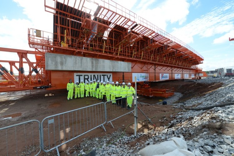 Representatives from Halton Borough Council, Mersey Gateway Crossings Board and the Merseylink project team unveil the movable scaffolding system's new name.