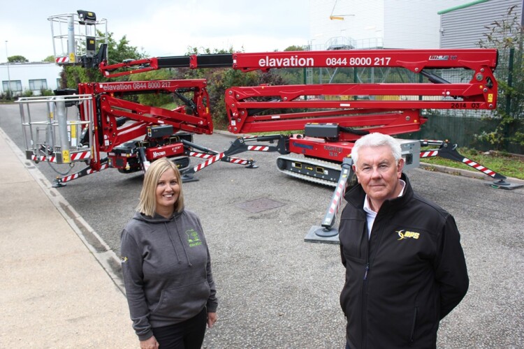 Elavation Platforms' new special equipment manager Mandy McClement-John (left), and APS managing director Steve Couling, with a Hinowa LL 17.75 Performance IIIS and an LL 26.14 Performance IIIS.