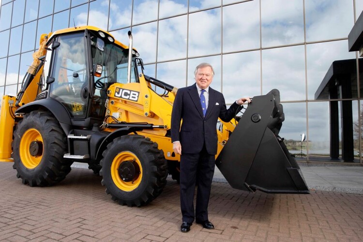  Lord Bamford, owner of the business, with one of his backhoe loaders