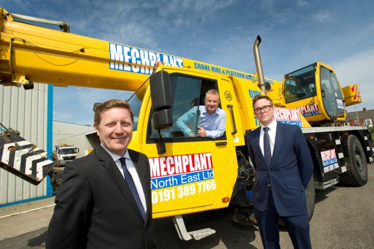 Mechplant managing director Stephen Makinson in the cab of the new Demag; Yorkshire Bank managers David Jeffery and David Cooper are in the suits. 