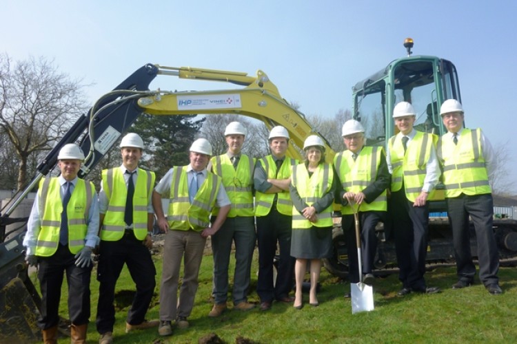 VIPs pose for turf cutting