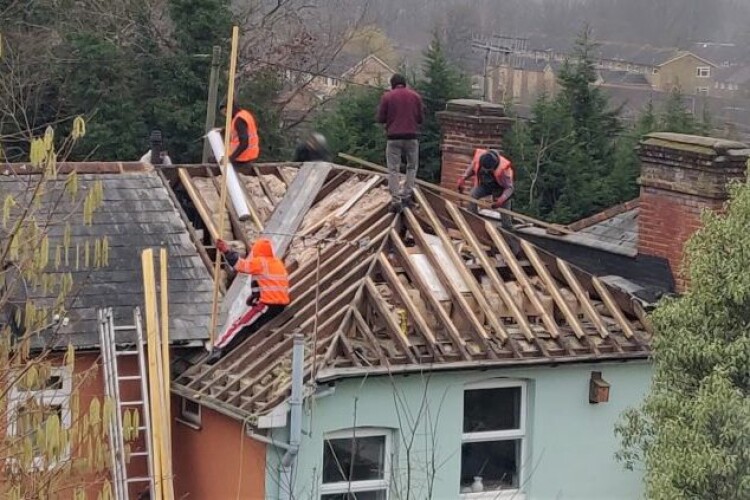 Photo of Weather Master Roofing at work on a house in Dorking, supplied by the Health & Safety Executive 