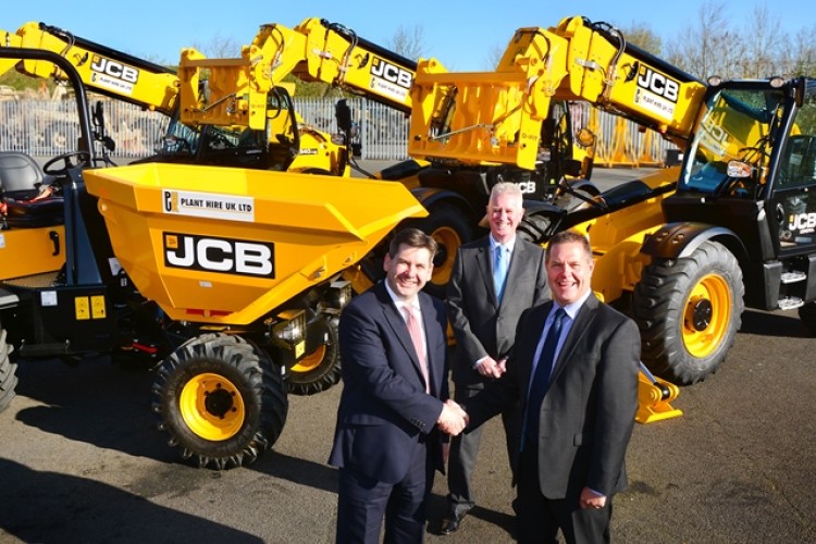 JCB sales director Dan Thompstone (left) seals the deal with PHUK boss Graham Jones, while Gunn JCB sales director John Dolphin (centre) looks on