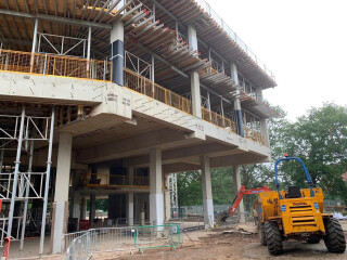 Transfer beams cantilever out 3.5m over the main facade and carry the columns for the structure above