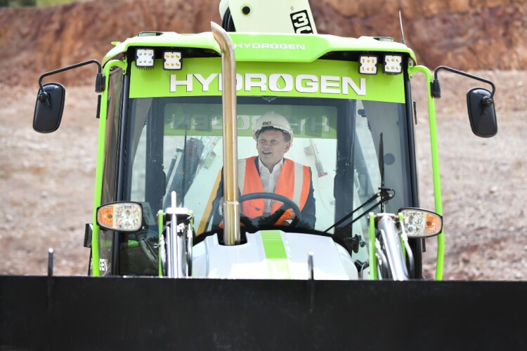 Energy secretary Grant Shapps drives one of JCB's hydrogen-powered backhoe loader prototypes