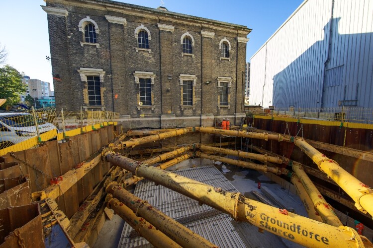 The excavation is bounded on one side by the Grade II listed Greenwich Pumping Station