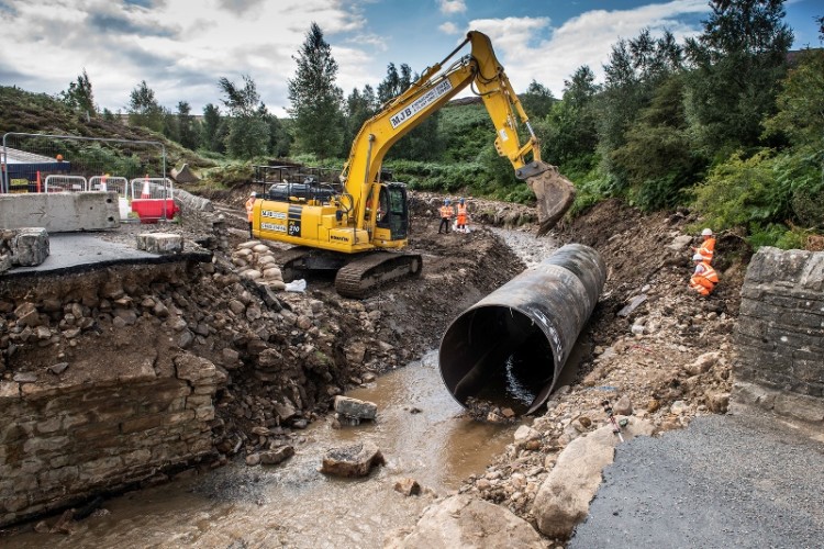 Wind turbine column sections have been placed in the beck to support a temporary replacement bridge