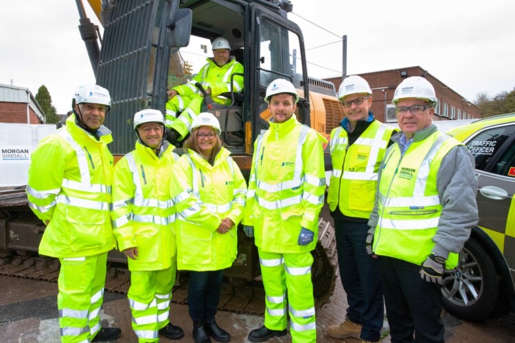 Pictured left to right are  National Highways personnel Roxroy Taylor, Ciprian Ciuraru, Alison Gallizioli, Colin Lowther (in cab) and Steven Tucker, with Richard Fielding and Tony Fitzgerald of Morgan Sindall Construction
