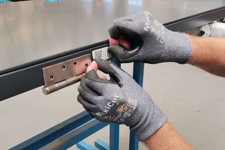 Tagging a door in the factory with its QR code giving access to product data and inspection/service log