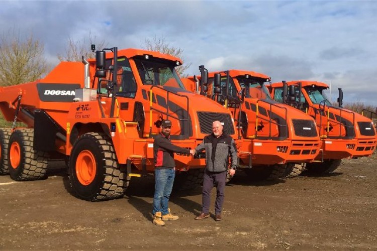 RJT assistant plant manager Euan Heard at the handover of the Doosan DA30 ADTs from Darren Nicholson, area sales manager for Gordons