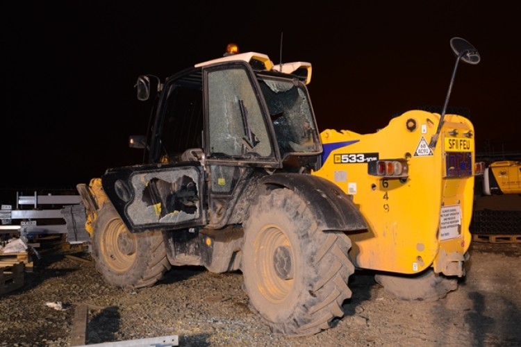 Windows were smashed on construction machinery.