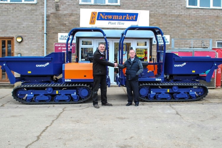 Dealer Ian Staniforth of ICB (left) hands over the new dumpers to NPH operations director Ashley Tarrant