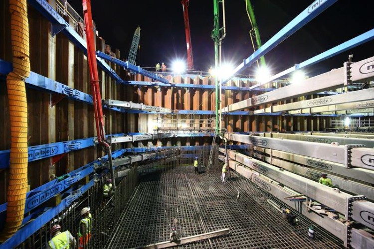 Concrete is poured into the pit to form the floor