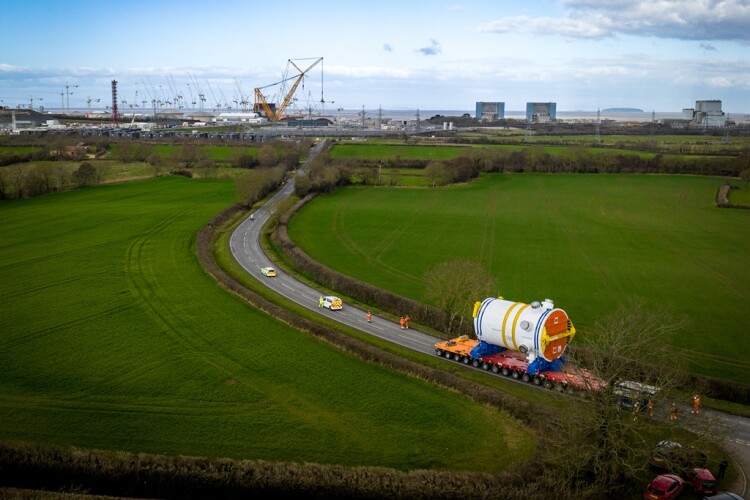 With the cranes of Hinkley Point C in the background, the 500-tonne load completes the last few miles of its journey from France by road