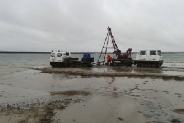 Surveying work on the mudflats