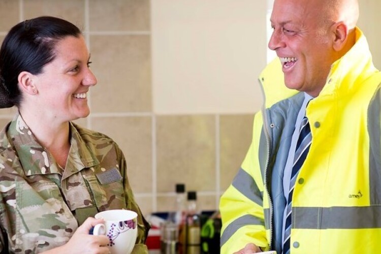 Man from Amey having a cup of tea with a soldier