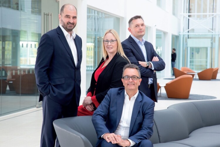 The board of BAM Construct UK (left to right): Doug Keillor, Andrea Singh (HR), Neil McGruer (finance) and (seated) CEO James Wimpenny