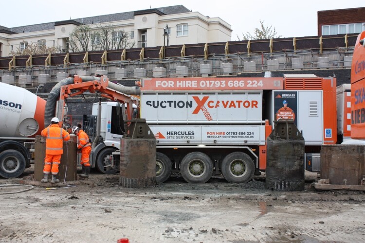 A vacuum excavator removes surplus material while it is still wet