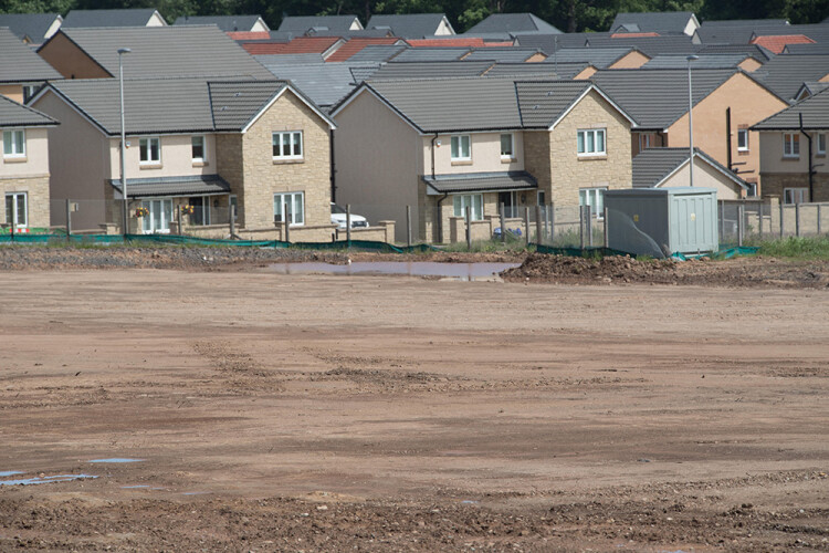 New houses on a brownfield site in Bishopton, Renfrewshire with remediated land in the foreground